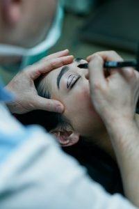 a surgeon marking a patient s eyelid